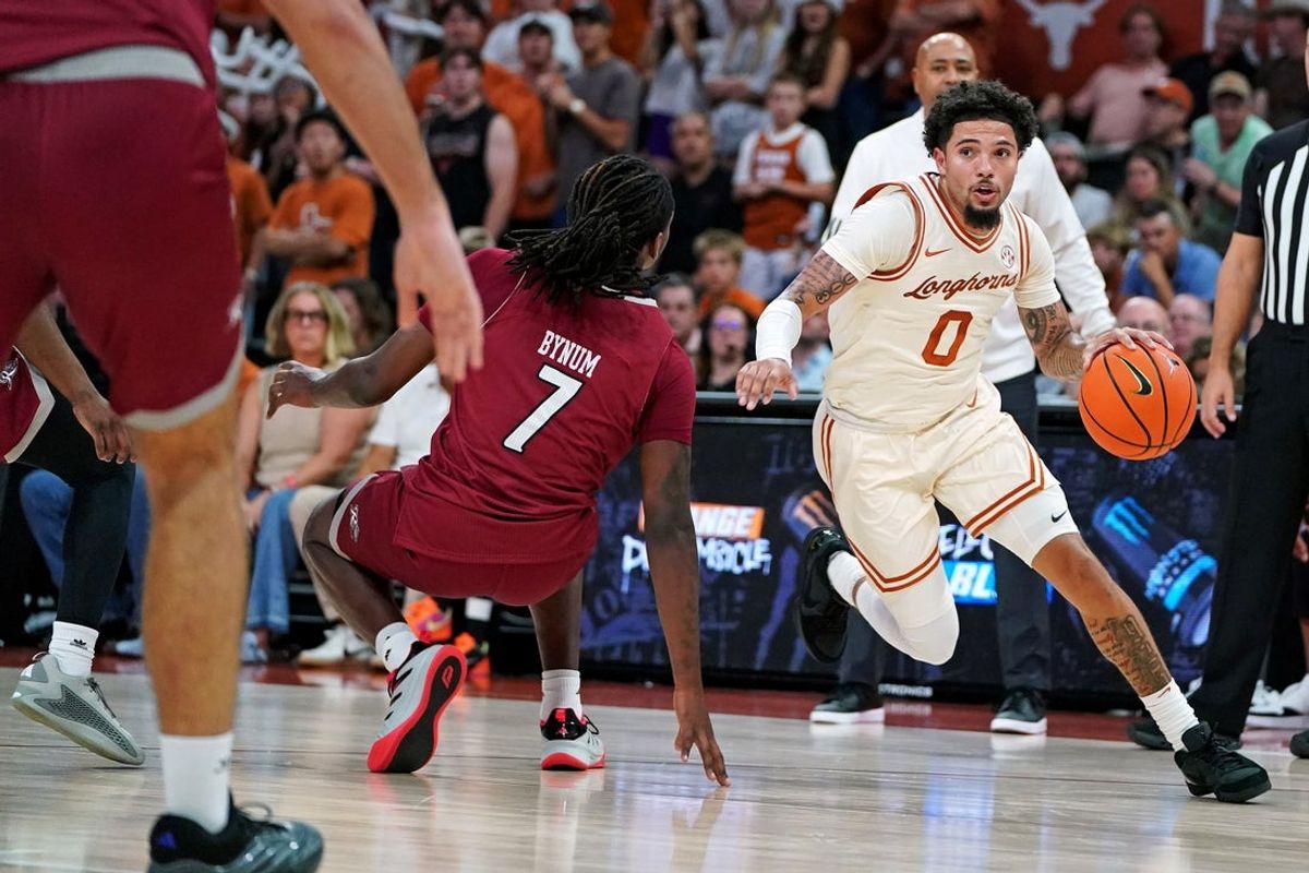 Nov 18, 2025; Austin, Texas, USA; Texas Longhorns guard Jordan Pope (0) drives the ball to the basket against Rider Broncs forward Davis Bynim (7) during the first half at Moody Center. Mandatory Credit: Dustin Safranek-Imagn Images