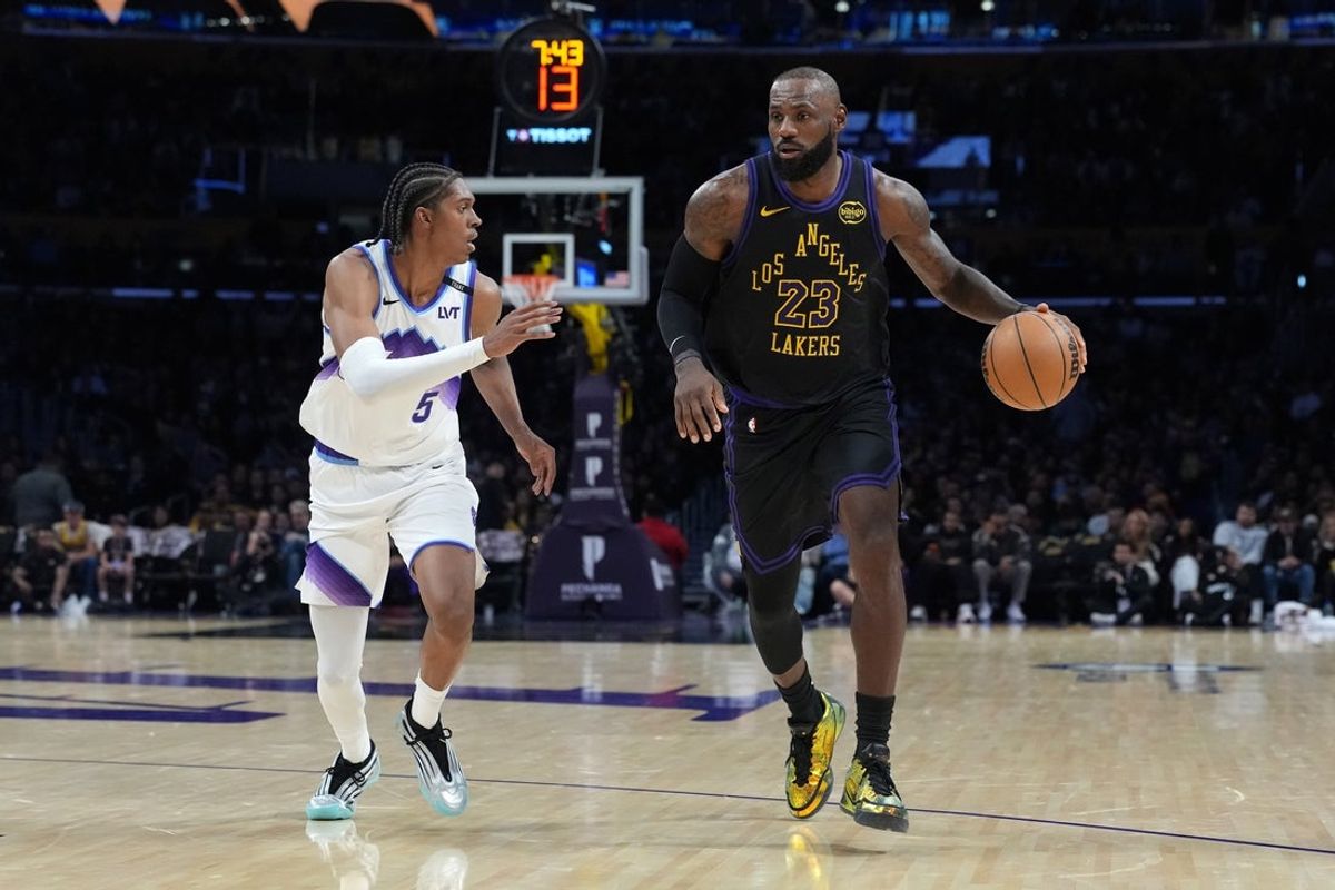 Nov 18, 2025; Los Angeles, California, USA; Los Angeles Lakers forward LeBron James (23) dribbles the ball against Utah Jazz forward Cody Williams (5) in the second quarter at Crypto.com Arena. Mandatory Credit: Kirby Lee-Imagn Images