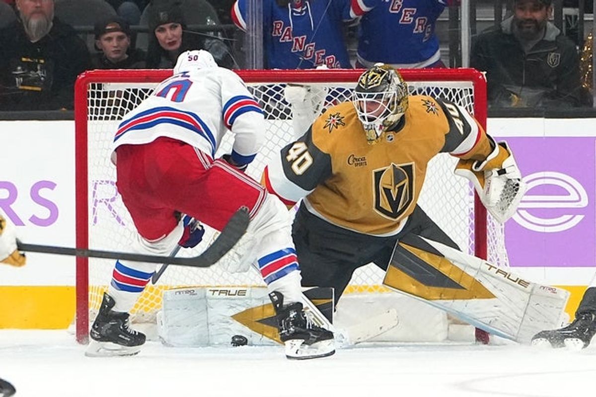 Nov 18, 2025; Las Vegas, Nevada, USA; Vegas Golden Knights goaltender Akira Schmid (40) makes a save against New York Rangers left wing Will Cuylle (50) during the third period at T-Mobile Arena. Mandatory Credit: Stephen R. Sylvanie-Imagn Images