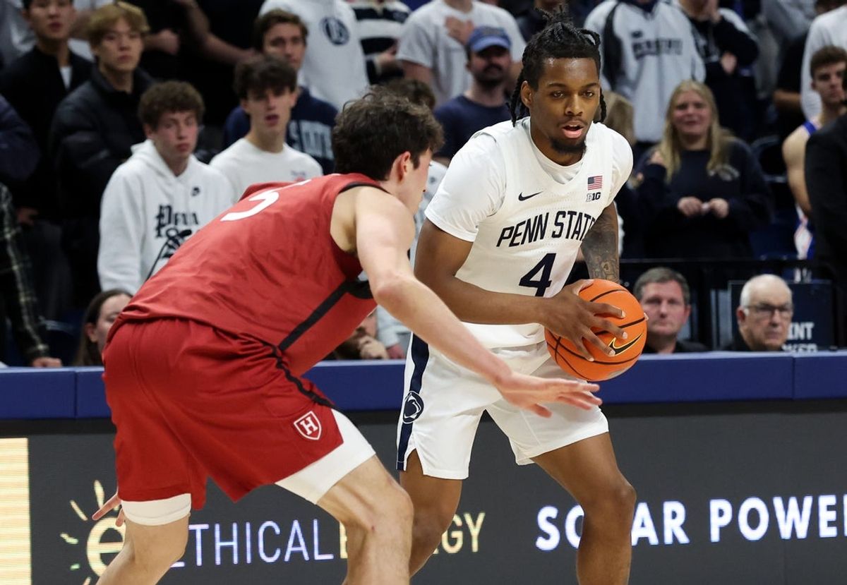 Nov 19, 2025; University Park, Pennsylvania, USA; Penn State Nittany Lions guard Kayden Mingo (4) holds the ball as Harvard Crimson guard Ben Eisendrath (5) defends during the first half at Bryce Jordan Center. Mandatory Credit: Matthew O'Haren-Imagn Images