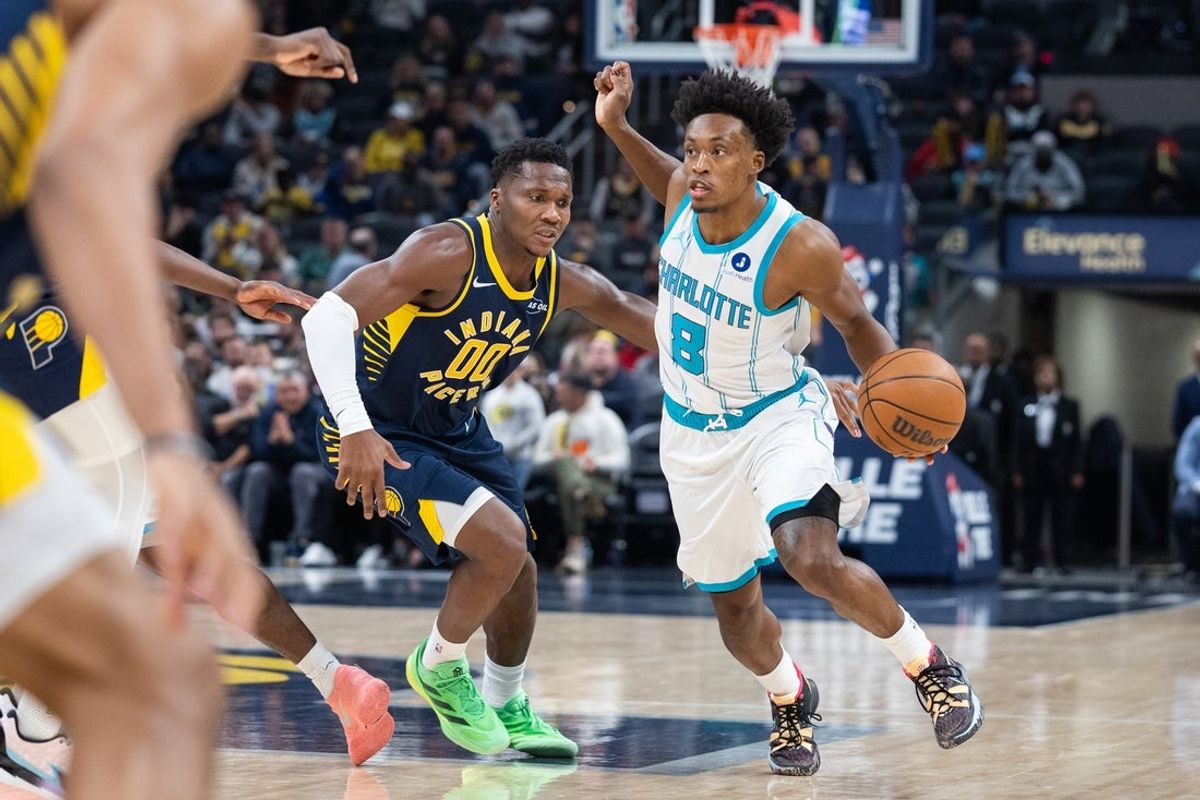 Nov 19, 2025; Indianapolis, Indiana, USA; Charlotte Hornets forward Grant Williams (2) dribbles the ball while Indiana Pacers guard Bennedict Mathurin (00) defends in the first half at Gainbridge Fieldhouse. Mandatory Credit: Trevor Ruszkowski-Imagn Images