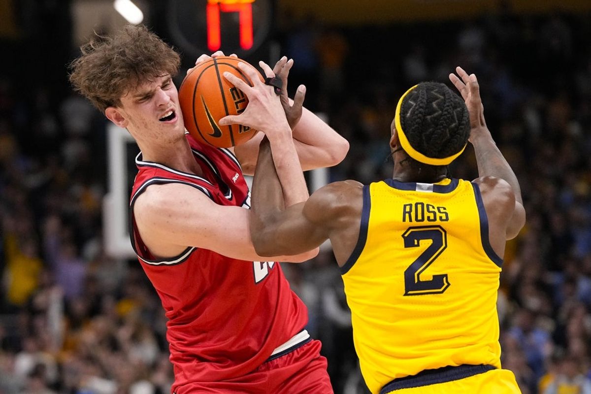 Nov 19, 2025; Milwaukee, Wisconsin, USA;  Dayton Flyers forward Amael L'Etang (29) and Marquette Golden Eagles guard Chase Ross (2) battle for the ball during the first half at Fiserv Forum. Mandatory Credit: Jeff Hanisch-Imagn Images