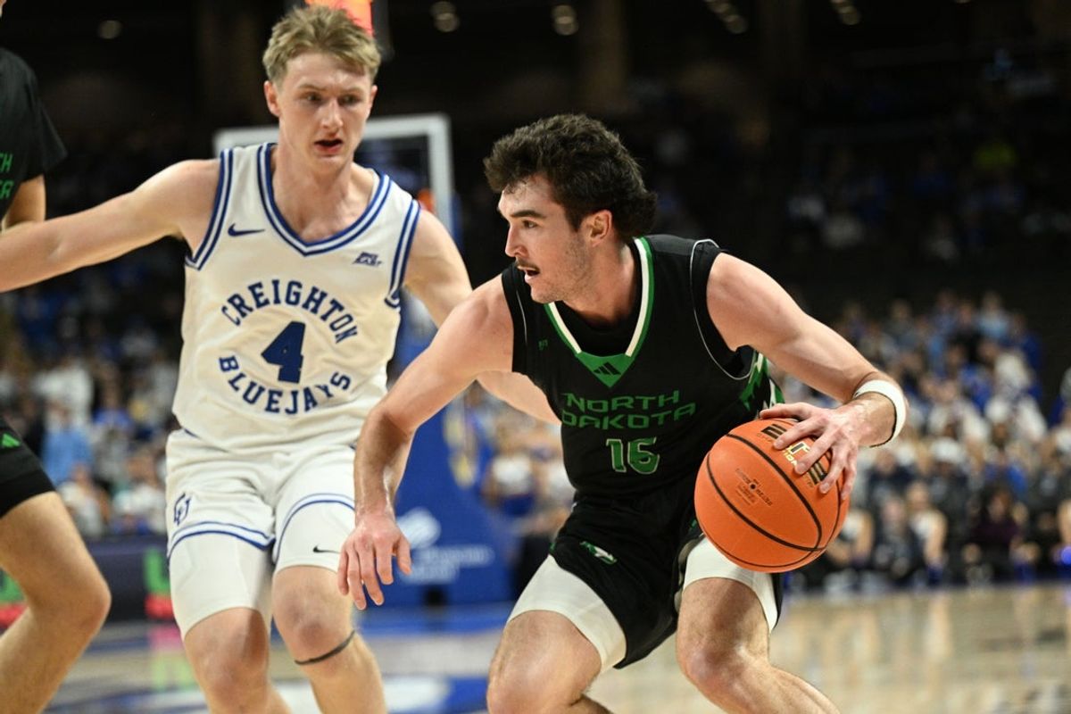 Nov 19, 2025; Omaha, Nebraska, USA;  North Dakota Fighting Hawks guard Garrett Anderson (16) drives against Creighton Bluejays guard Josh Dix (4) during the first half at CHI Health Center Omaha. Mandatory Credit: Steven Branscombe-Imagn Images