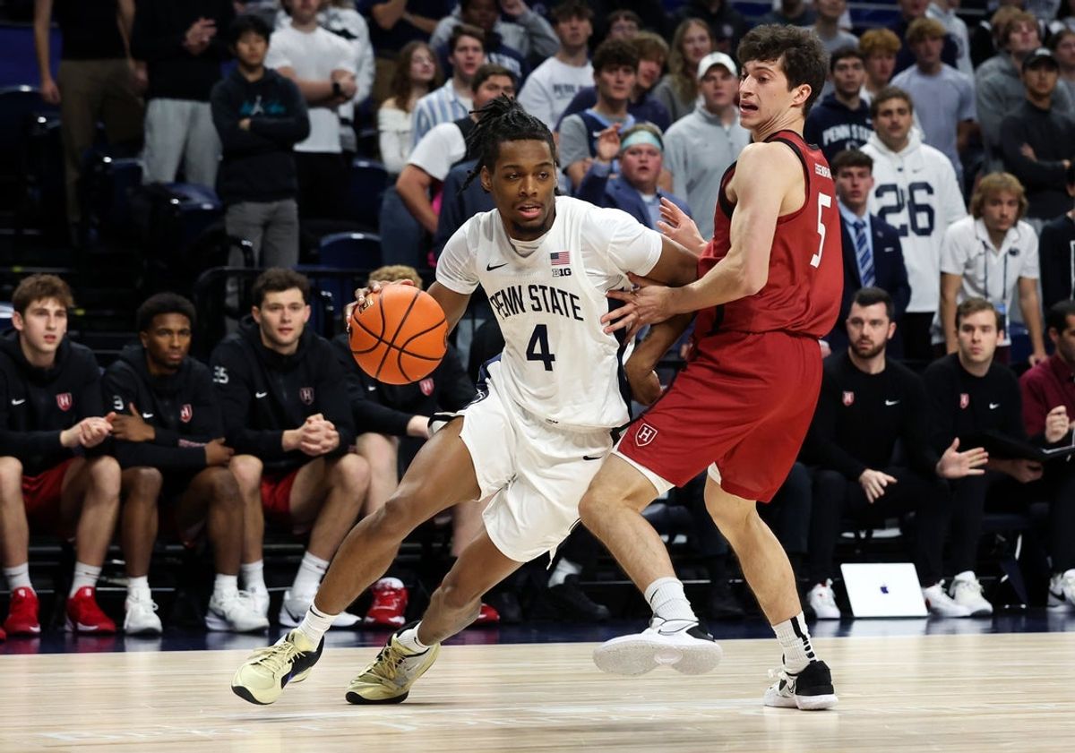 Nov 19, 2025; University Park, Pennsylvania, USA; Penn State Nittany Lions guard Kayden Mingo (4) dribbles the ball around Harvard Crimson guard Ben Eisendrath (5) during the first half at Bryce Jordan Center. Mandatory Credit: Matthew O'Haren-Imagn Images