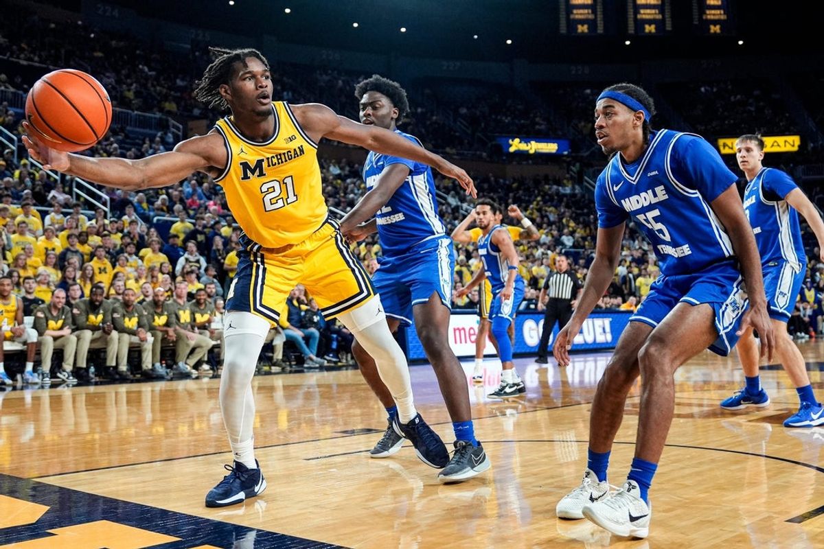Michigan forward Morez Johnson Jr. (21) tries to save the ball from going out of bound against Middle Tennessee guard Sean Smith (55) during the second half at Crisler Center in Ann Arbor on Wednesday, November 19, 2025.