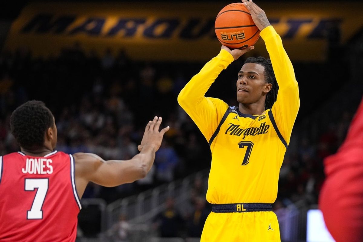 Nov 19, 2025; Milwaukee, Wisconsin, USA;  Marquette Golden Eagles guard Zaide Lowery (7) shoots over Dayton Flyers forward Keonte Jones (7) during the second half at Fiserv Forum. Mandatory Credit: Jeff Hanisch-Imagn Images