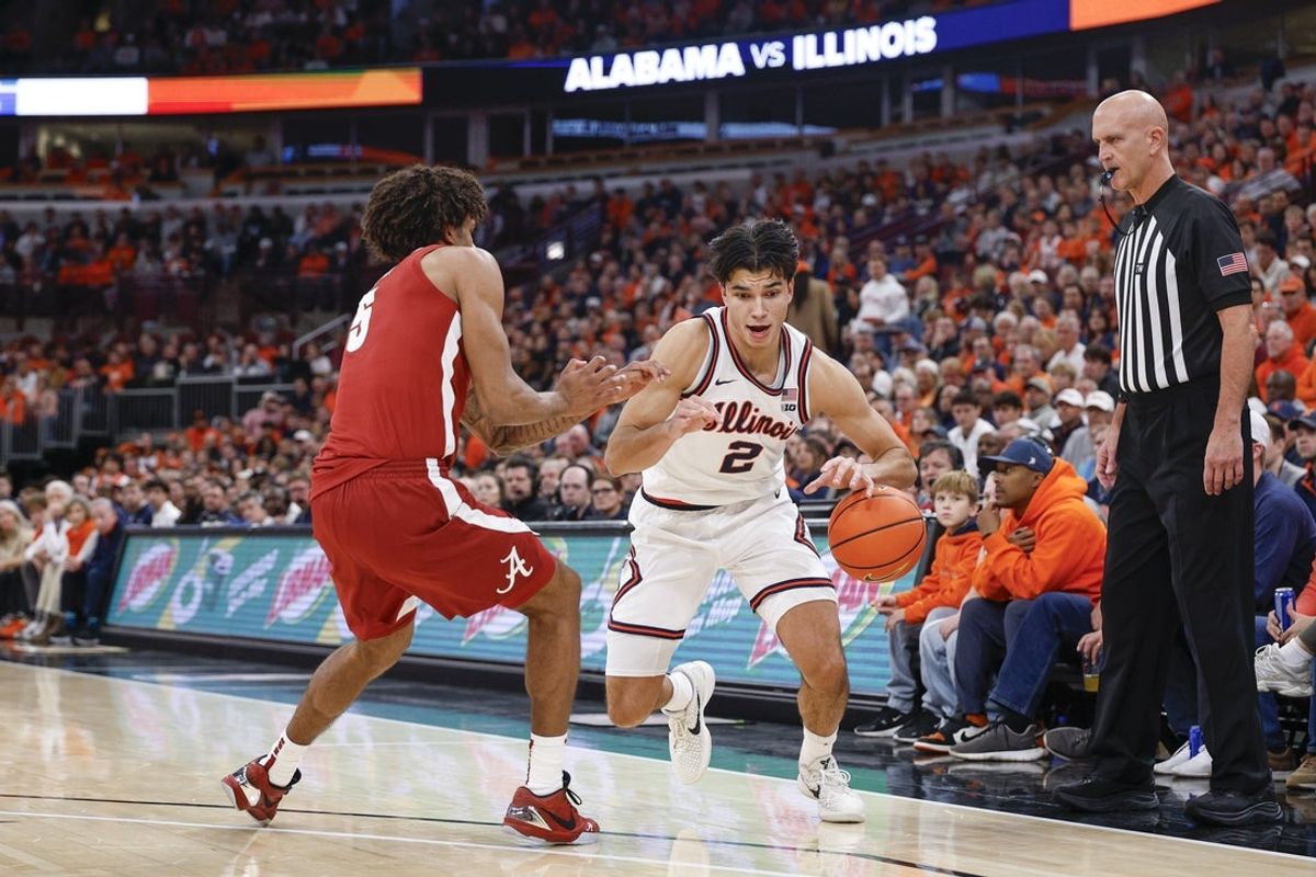 Nov 19, 2025; Chicago, Illinois, USA; Illinois Fighting Illini guard Andrej Stojakovic (2) drives to the basket against Alabama Crimson Tide forward Amari Allen (5) during the first half at United Center. Mandatory Credit: Kamil Krzaczynski-Imagn Images