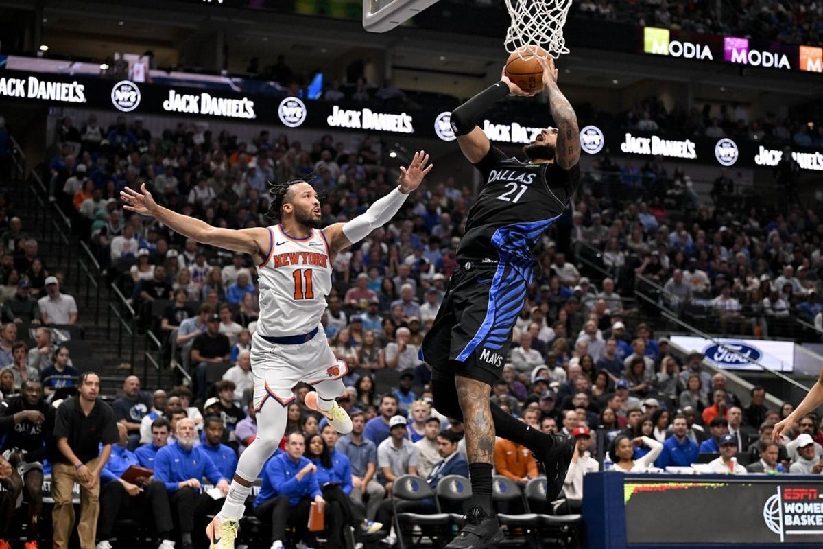 Nov 19, 2025; Dallas, Texas, USA; Dallas Mavericks forward Daniel Gafford (21) is fouled by New York Knicks guard Jalen Brunson (11) during the second quarter at the American Airlines Center. Mandatory Credit: Jerome Miron-Imagn Images