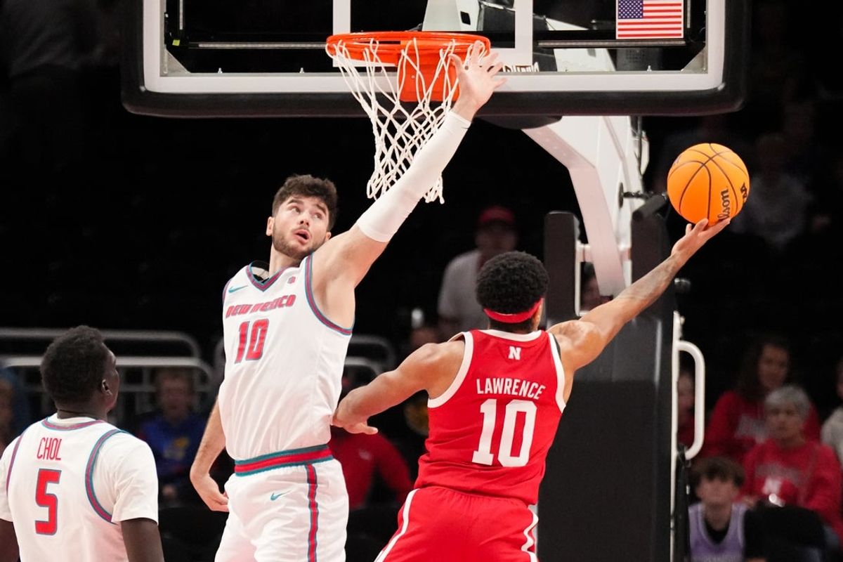 Nov 20, 2025; Kansas City, MO, USA; Nebraska Cornhuskers guard Jamarques Lawrence (10) shoots a layup as New Mexico Lobos forward Tomislav Buljan (10) defends during the first half of the game at T-Mobile Center. Mandatory Credit: Denny Medley-Imagn Images
