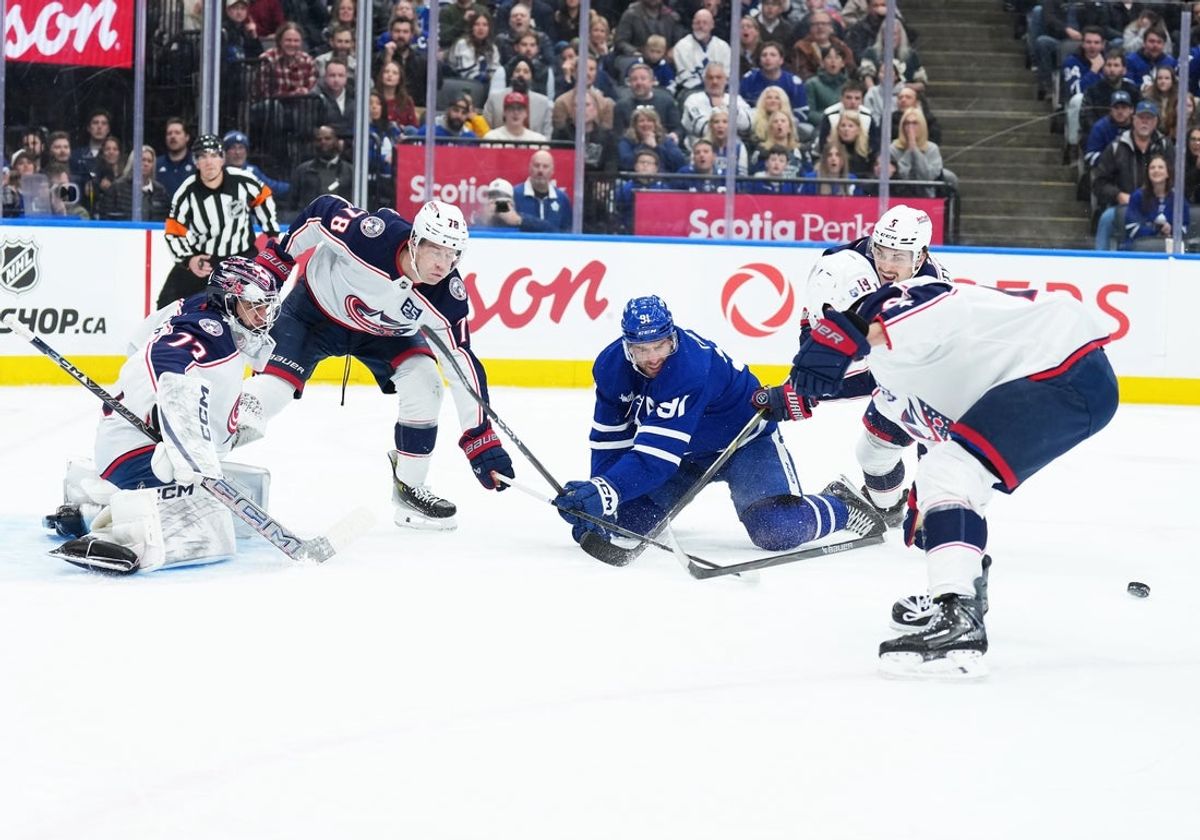 Nov 20, 2025; Toronto, Ontario, CAN; Toronto Maple Leafs center John Tavares (91) battles for the puck with Columbus Blue Jackets defenseman Damon Severson (78) during the first period at Scotiabank Arena. Mandatory Credit: Nick Turchiaro-Imagn Images