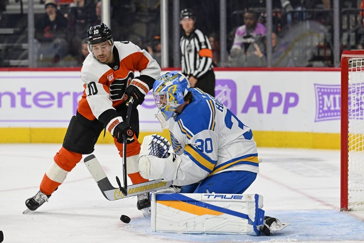 Nov 20, 2025; Philadelphia, Pennsylvania, USA; Philadelphia Flyers right wing Bobby Brink (10) reaches for the puck as St. Louis Blues goaltender Joel Hofer (30) makes a save during the first period at Xfinity Mobile Arena. Mandatory Credit: Eric Hartline-Imagn Images