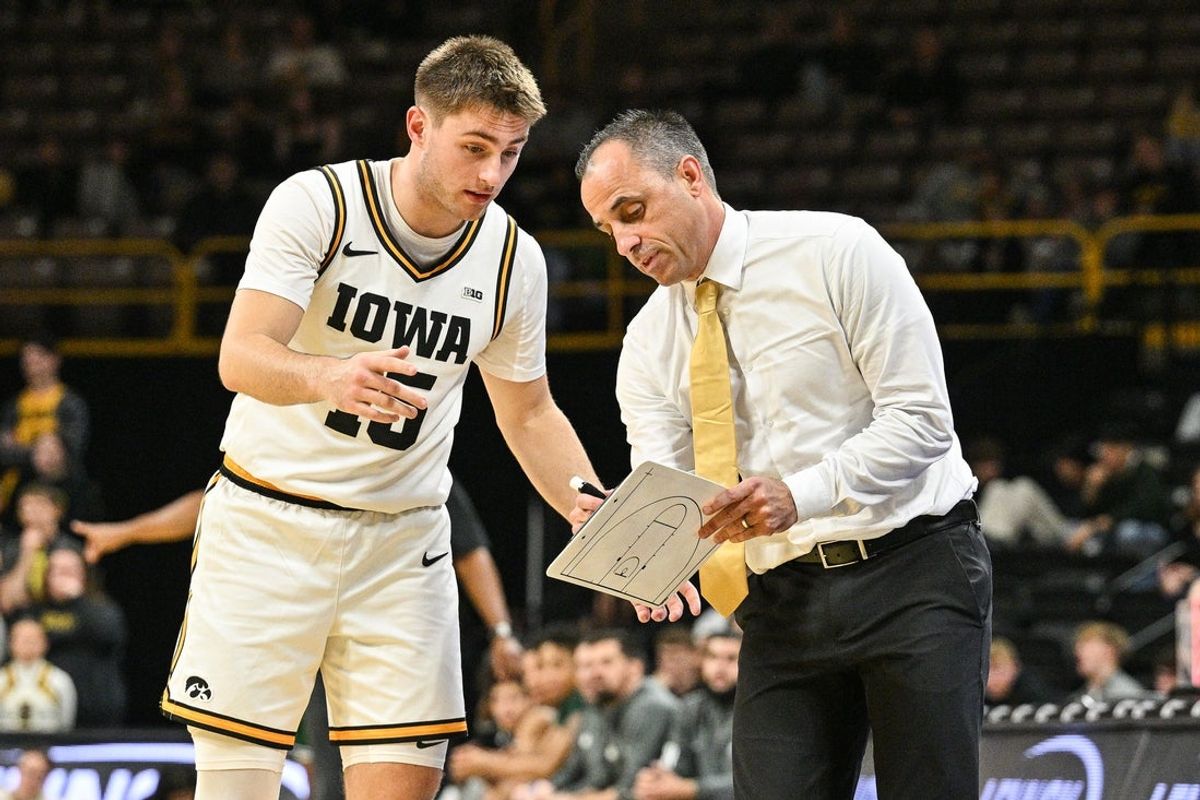 Nov 20, 2025; Iowa City, Iowa, USA; Iowa Hawkeyes head coach Ben McCollum reacts with guard Brendan Hausen (15) during the first half against the Chicago State Cougars at Carver-Hawkeye Arena. Mandatory Credit: Jeffrey Becker-Imagn Images