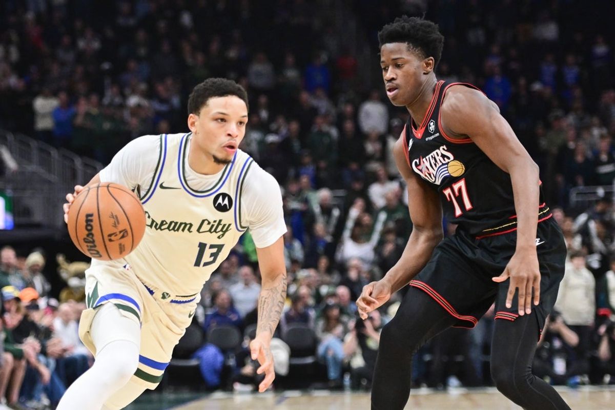 Nov 20, 2025; Milwaukee, Wisconsin, USA; Milwaukee Bucks guard Ryan Rollins (13) drive for the basket against Philadelphia 76ers guard VJ Edgecombe (77) in the first quarter at Fiserv Forum. Mandatory Credit: Benny Sieu-Imagn Images