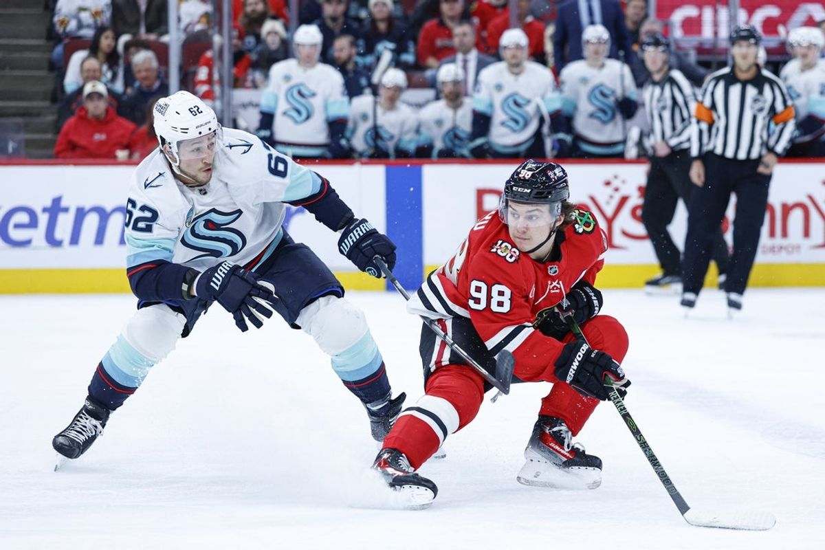 Nov 20, 2025; Chicago, Illinois, USA; Seattle Kraken defenseman Brandon Montour (62) defends against Chicago Blackhawks center Connor Bedard (98) during the first period at United Center. Mandatory Credit: Kamil Krzaczynski-Imagn Images