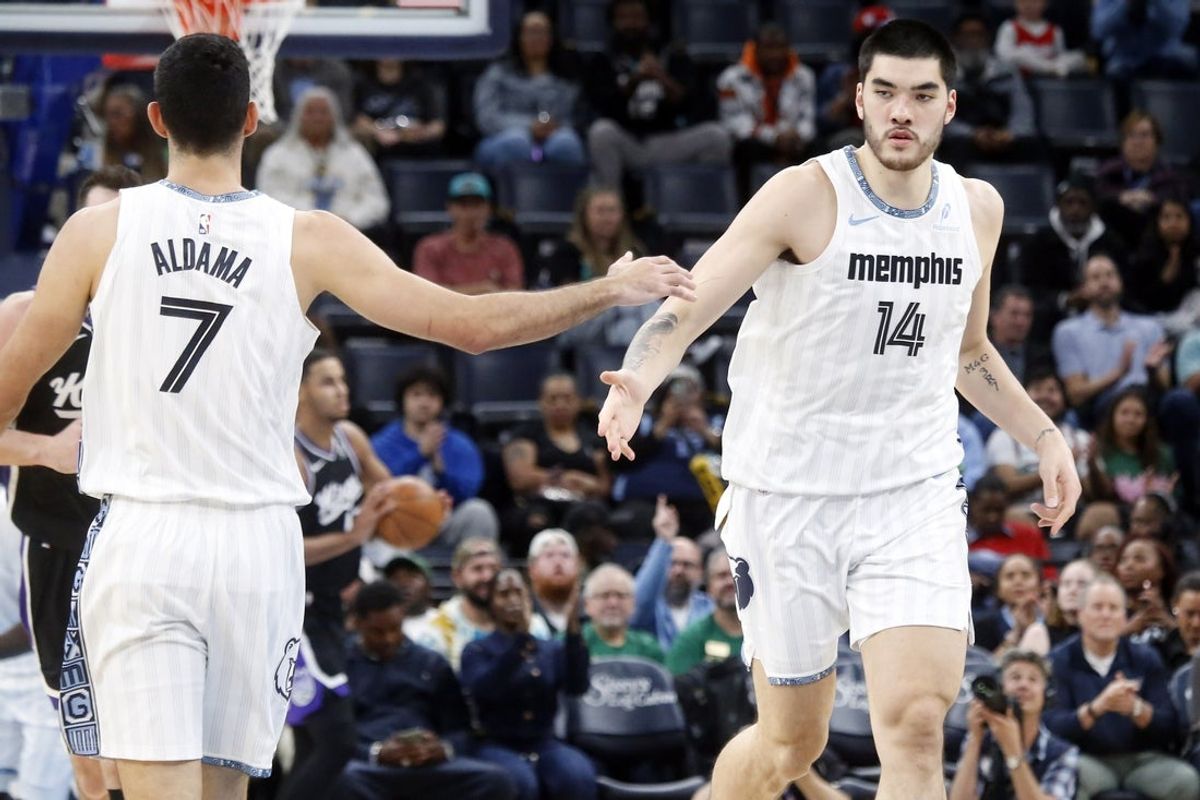 Nov 20, 2025; Memphis, Tennessee, USA; Memphis Grizzlies center Zach Edey (14) reacts with Memphis Grizzlies forward Santi Aldama (7) during the second quarter at FedExForum. Mandatory Credit: Petre Thomas-Imagn Images