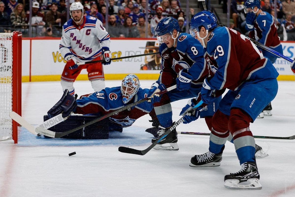 Nov 20, 2025; Denver, Colorado, USA; Colorado Avalanche defenseman Cale Makar (8) and center Nathan MacKinnon (29) look to clear the puck as goaltender Scott Wedgewood (41) defends in the first period against the New York Rangers at Ball Arena. Mandatory Credit: Isaiah J. Downing-Imagn Images