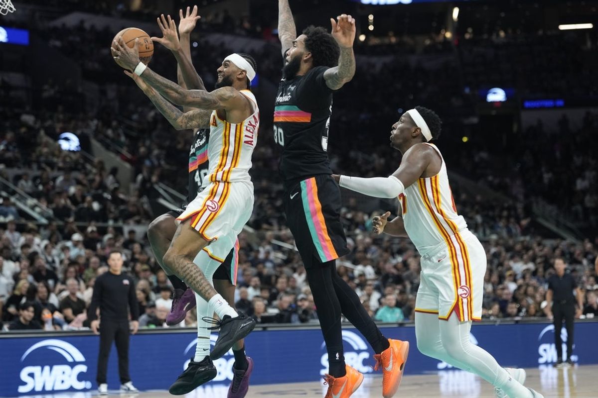 Nov 20, 2025; San Antonio, Texas, USA; Atlanta Hawks guard Nickeil Alexander-Walker (7) drives to the basket past San Antonio Spurs forward Julian Champagnie (30) during the second half at Frost Bank Center. Mandatory Credit: Scott Wachter-Imagn Images