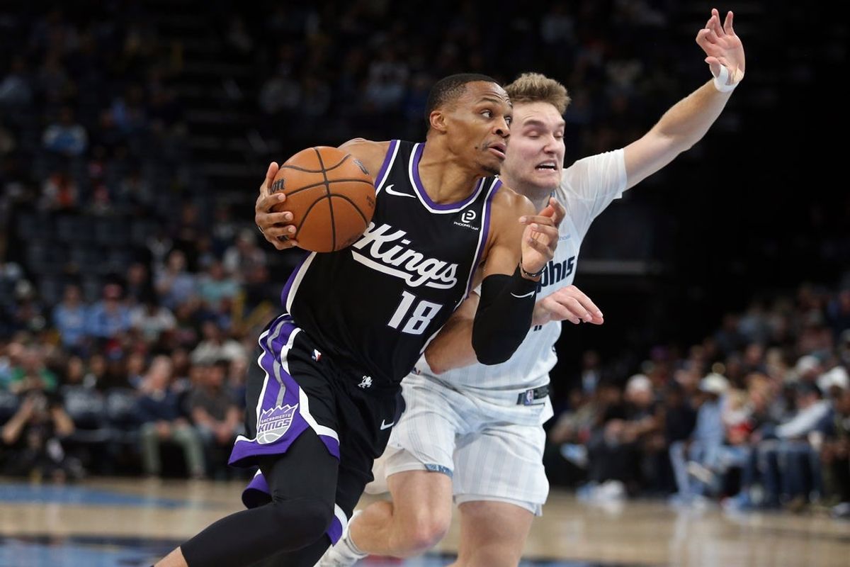 Nov 20, 2025; Memphis, Tennessee, USA; Sacramento Kings guard Russell Westbrook (18) drives to the basket as Memphis Grizzlies guard Cam Spencer (24) defends during the second quarter at FedExForum. Mandatory Credit: Petre Thomas-Imagn Images