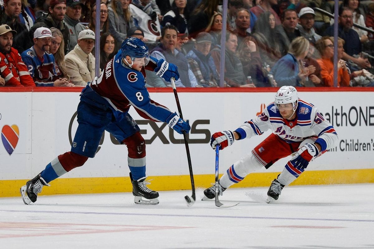 Nov 20, 2025; Denver, Colorado, USA; Colorado Avalanche defenseman Cale Makar (8) passes the puck as New York Rangers left wing Will Cuylle (50) defends in the third period at Ball Arena. Mandatory Credit: Isaiah J. Downing-Imagn Images