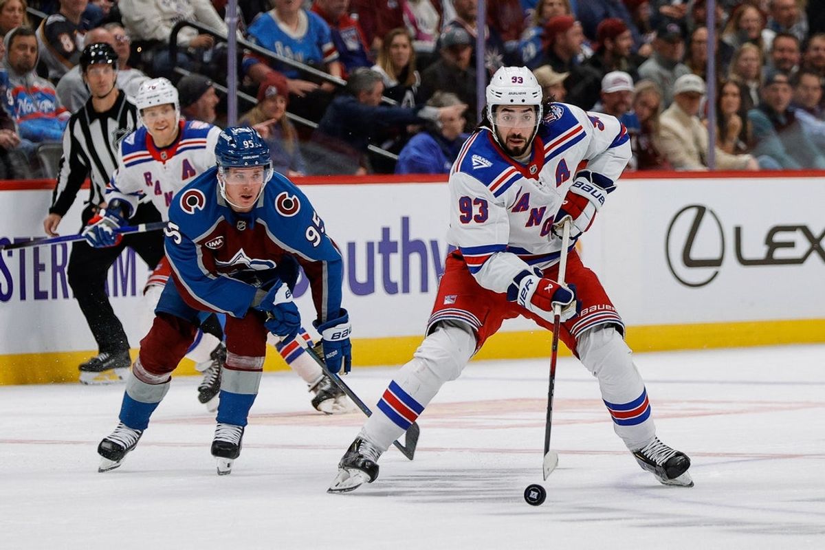 Nov 20, 2025; Denver, Colorado, USA; New York Rangers center Mika Zibanejad (93) controls the puck under pressure from Colorado Avalanche left wing Victor Olofsson (95) in the third period at Ball Arena. Mandatory Credit: Isaiah J. Downing-Imagn Images