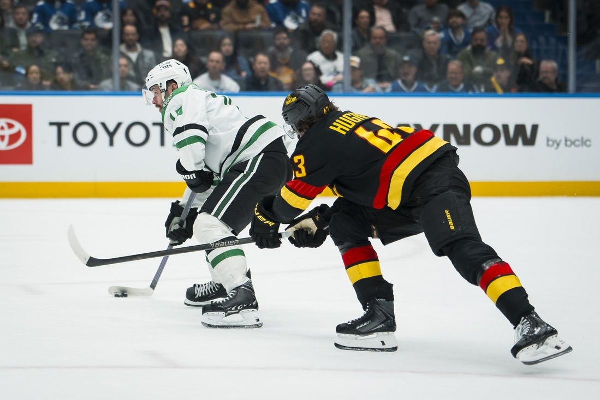 Nov 20, 2025; Vancouver, British Columbia, CAN; Dallas Stars forward Colin Blackwell (15) drives past Vancouver Canucks defenseman Quinn Hughes (43) in the third period at Rogers Arena. Mandatory Credit: Bob Frid-Imagn Images