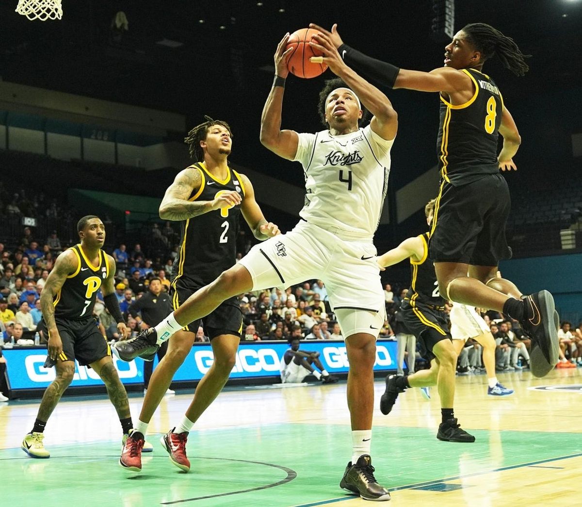 UCF’s Jamichael Stillwell (4) grabs a rebounds in front of Pittsburgh’s Omari Witherspoon (8) during a college basketball game Thursday, Nov. 20, 2025 at the Ocean Center.