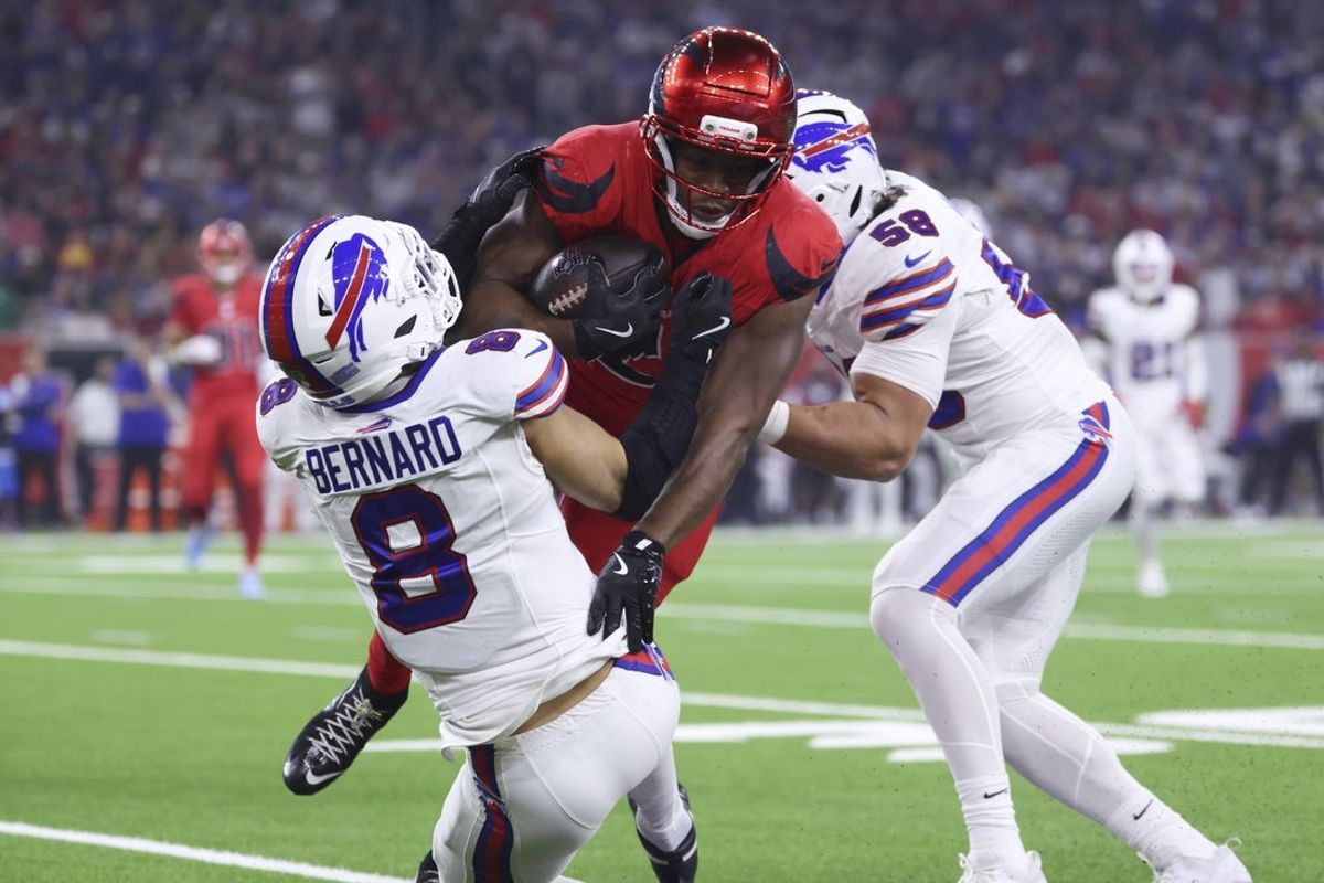 Nov 20, 2025; Houston, Texas, USA; Buffalo Bills linebacker Terrel Bernard (8) and linebacker Matt Milano (58) attempt to tackle Houston Texans running back Nick Chubb (21) during the game at NRG Stadium. Mandatory Credit: Troy Taormina-Imagn Images