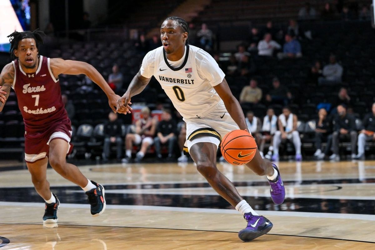 Nov 20, 2025; Nashville, Tennessee, USA;   Vanderbilt Commodores guard Mike James (0) drives to the basket past Texas Southern Tigers guard Zaire Hayes (7) during the second half at Memorial Gymnasium. Mandatory Credit: Steve Roberts-Imagn Images