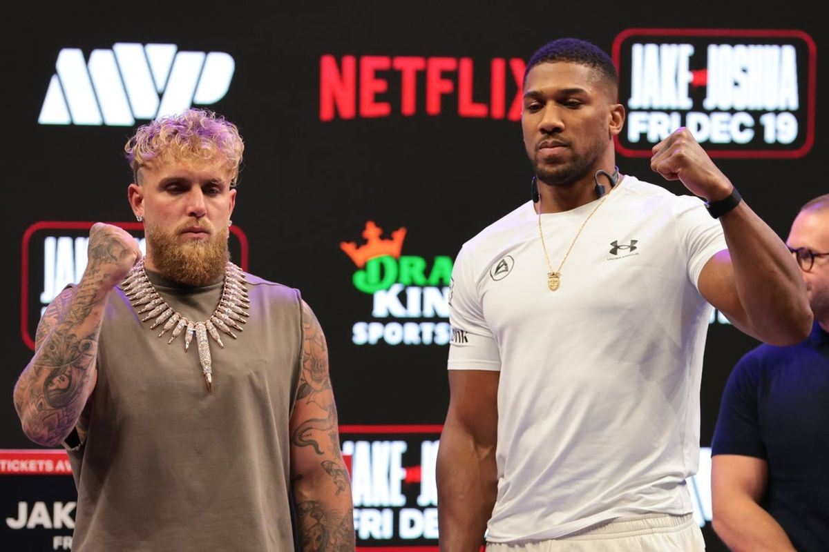 Nov 21, 2025; Miami, Florida, UNITED STATES; Jake Paul and Anthony Joshua face off after a press conference announcing their heavyweight boxing match at Kayesa Center. Mandatory Credit: Sam Navarro-Imagn Images