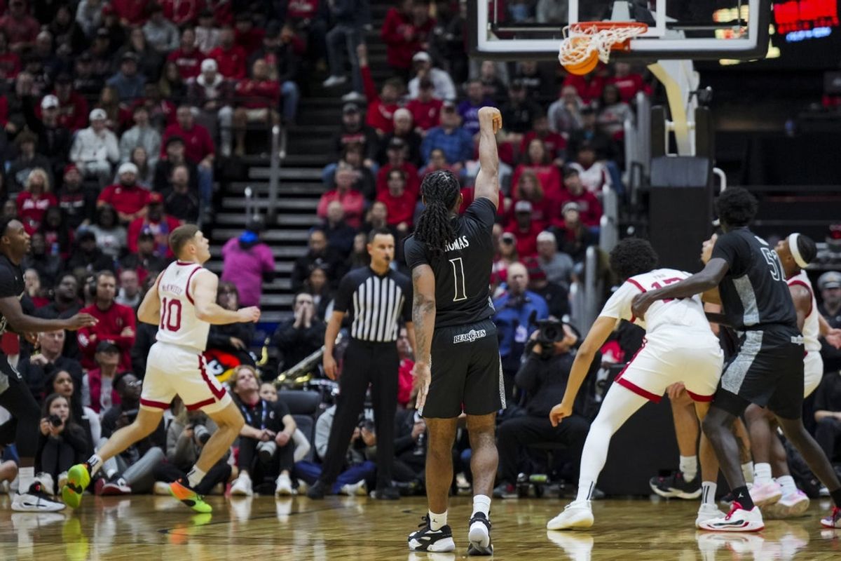 Nov 21, 2025; Cincinnati, Ohio, USA; Cincinnati Bearcats guard Day Day Thomas (1) reacts to making a 3-point shot against the Louisville Cardinals in the first half at Heritage Bank Center. Mandatory Credit: Aaron Doster-Imagn Images