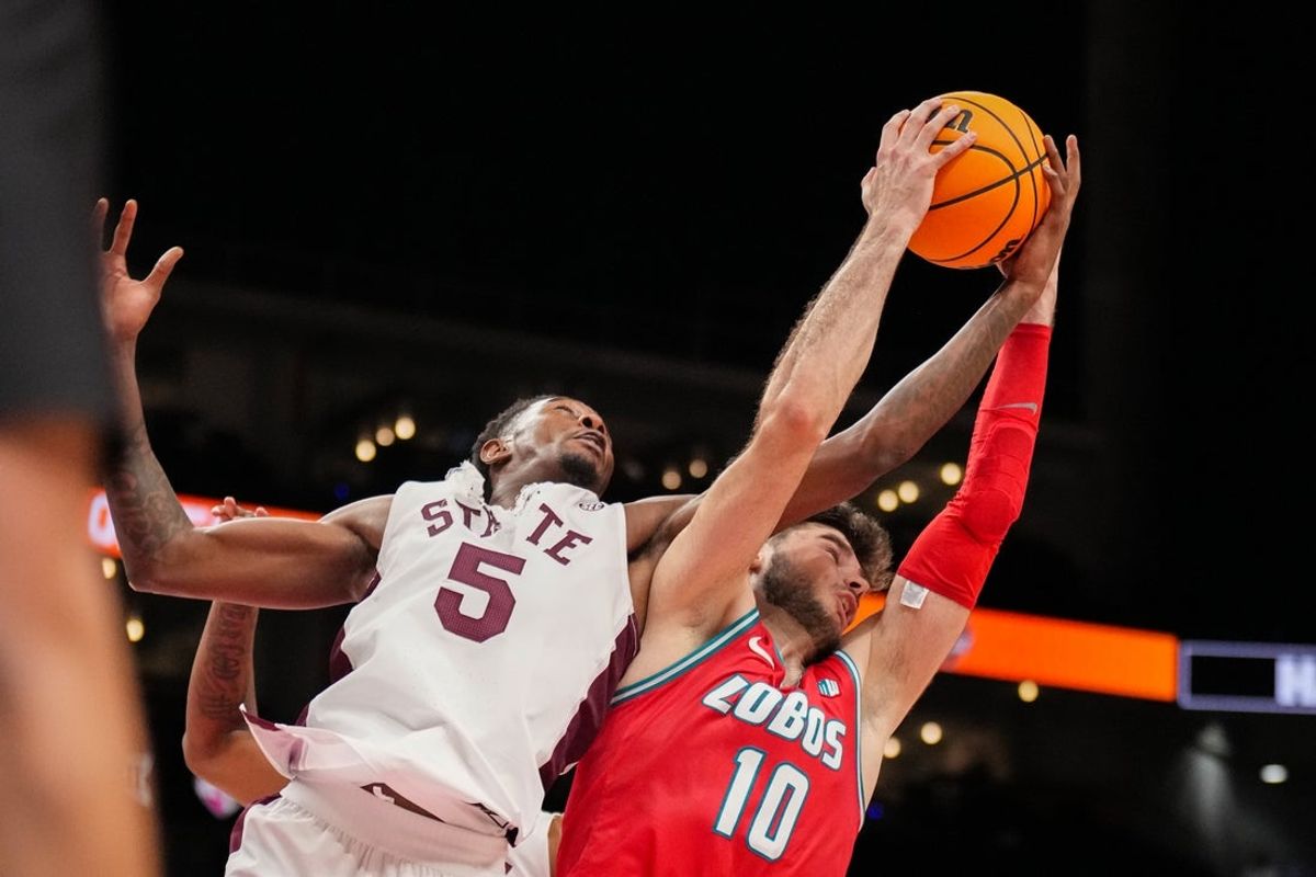 Nov 21, 2025; Kansas City, MO, USA; Mississippi State Bulldogs guard Shawn Jones Jr. (5) and New Mexico Lobos forward Tomislav Buljan (10) fight for a rebound during the second half of the game at T-Mobile Center. Mandatory Credit: Denny Medley-Imagn Images