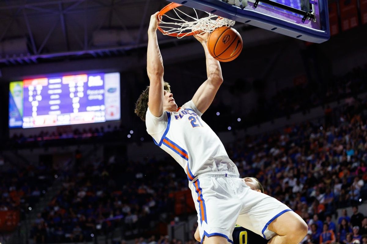 Nov 21, 2025; Gainesville, Florida, USA; Florida Gators forward Alex Condon (21) dunks the ball against the Merrimack Warriors during the second half at Exactech Arena at the Stephen C. O'Connell Center. Mandatory Credit: Matt Pendleton-Imagn Images