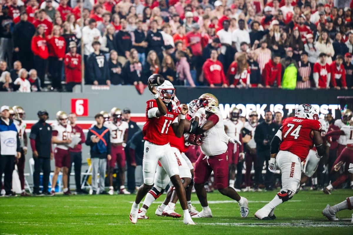 Nov 21, 2025; Raleigh, North Carolina, USA; NC State Wolfpack quarterback CJ Bailey (11) throws the ball during the first half of the game against Florida State Seminoles at Carter-Finley Stadium. Mandatory Credit: Jaylynn Nash-Imagn Images