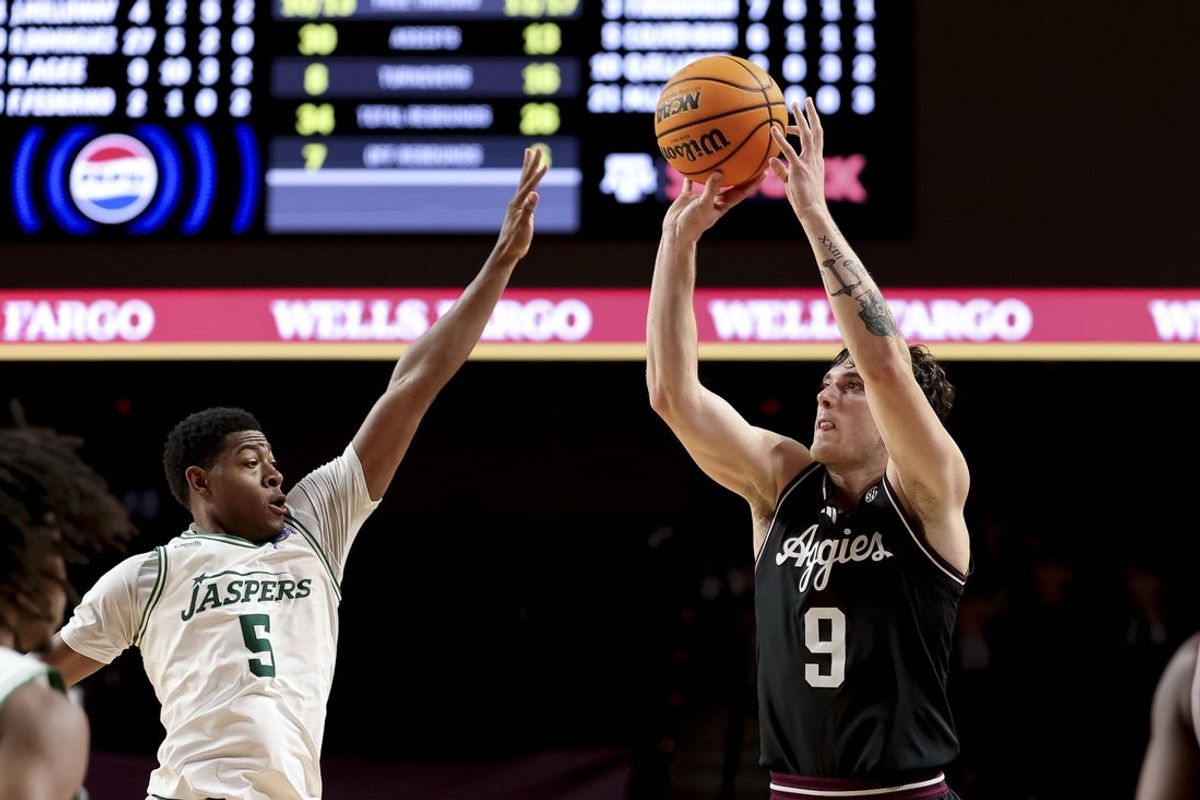 Nov 21, 2025; College Station, Texas, USA; Texas A&M Aggies guard Ruben Dominguez (9) shoots a three point basket for a program record 10 three point baskets in a single game against the Manhattan Jaspers during the second half at Reed Arena. Mandatory Credit: Maria Lysaker-Imagn Images