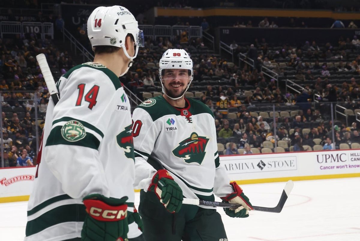 Nov 21, 2025; Pittsburgh, Pennsylvania, USA;  Minnesota Wild center Joel Eriksson Ek (14) and left wing Marcus Johansson (90) react on the ice against the Pittsburgh Penguins during the third period at PPG Paints Arena. Mandatory Credit: Charles LeClaire-Imagn Images