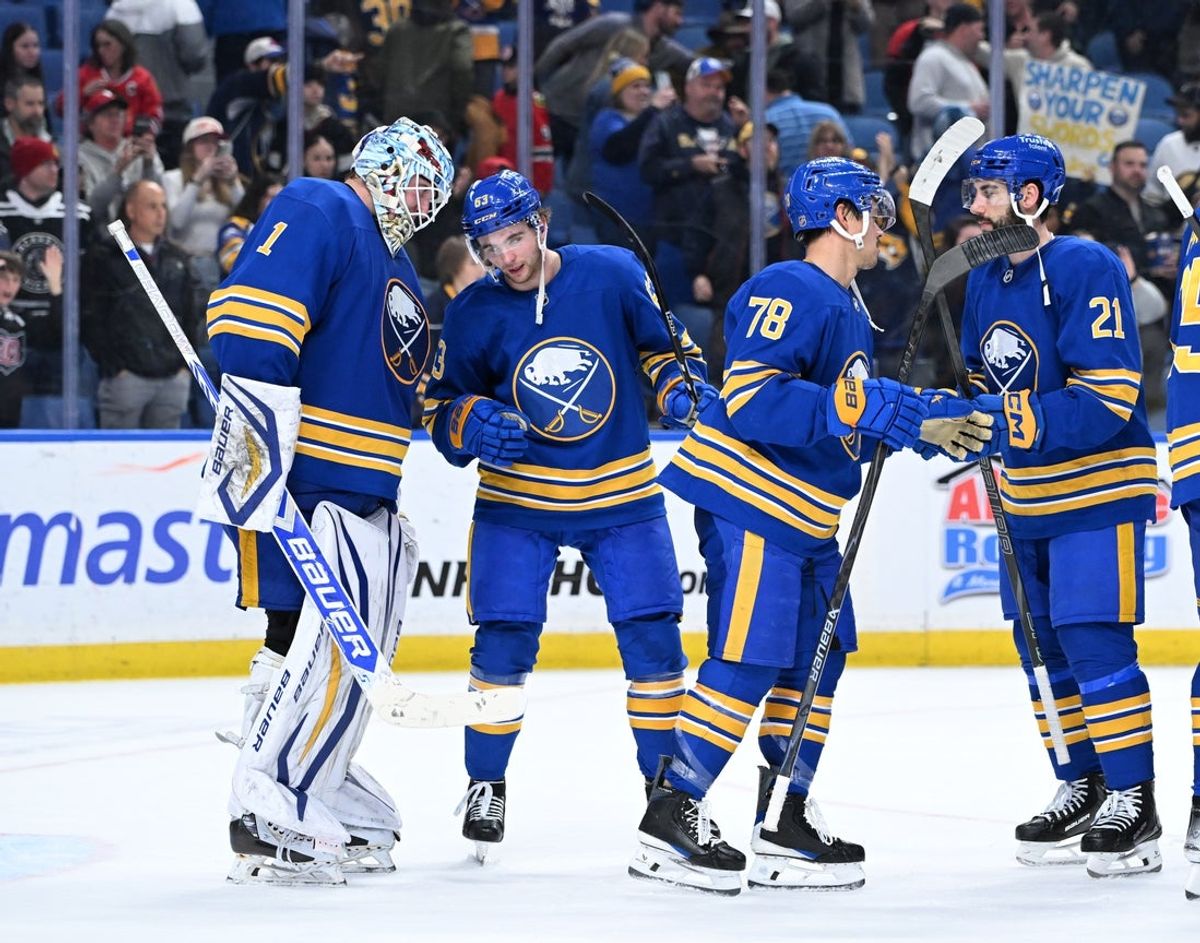 Nov 21, 2025; Buffalo, New York, USA; Buffalo Sabres right wing Isak Rosen (63) congratulates goaltender Ukko-Pekka Luukkonen (1) on a win against the Chicago Blackhawks at KeyBank Center. Mandatory Credit: Mark Konezny-Imagn Images