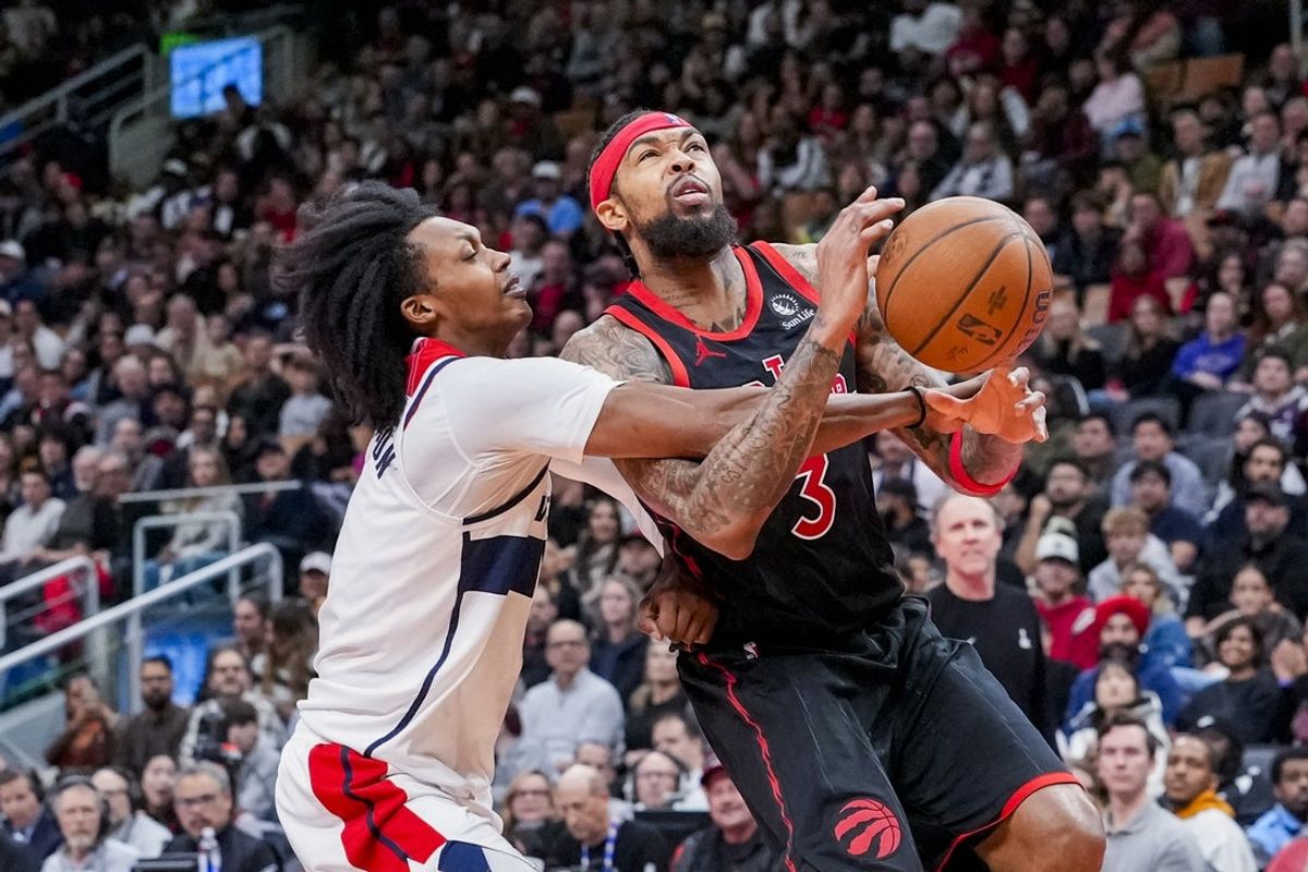 Nov 21, 2025; Toronto, Ontario, CAN;  Brandon Ingram (3) of the Toronto Raptors dribbles against Bub Carrington (7) of the Washington Wizards during the second half at Scotiabank Arena. Mandatory Credit: Kevin Sousa-Imagn Images
