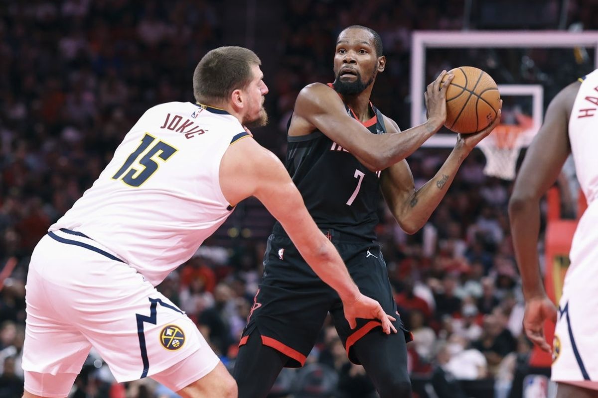 Nov 21, 2025; Houston, Texas, USA; Houston Rockets forward Kevin Durant (7) looks to pass the ball as Denver Nuggets center Nikola Jokic (15) defends during the second quarter at Toyota Center. Mandatory Credit: Troy Taormina-Imagn Images