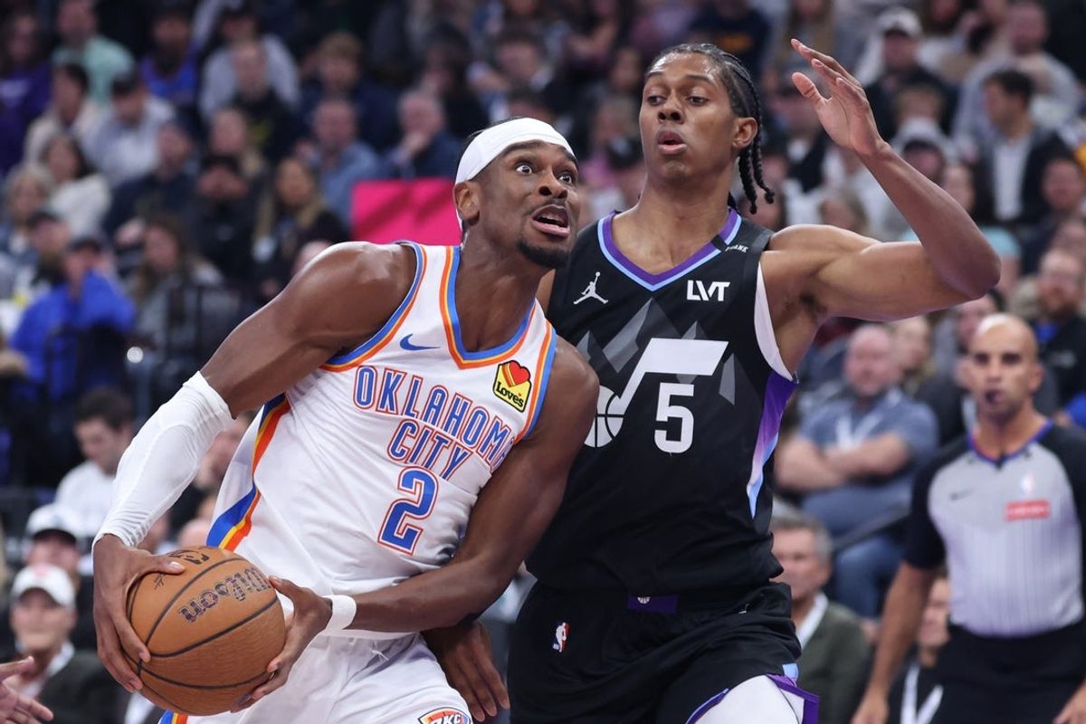 Nov 21, 2025; Salt Lake City, Utah, USA; Oklahoma City Thunder guard Shai Gilgeous-Alexander (2) drives against Utah Jazz forward Cody Williams (5) during the first half at Delta Center. Mandatory Credit: Rob Gray-Imagn Images