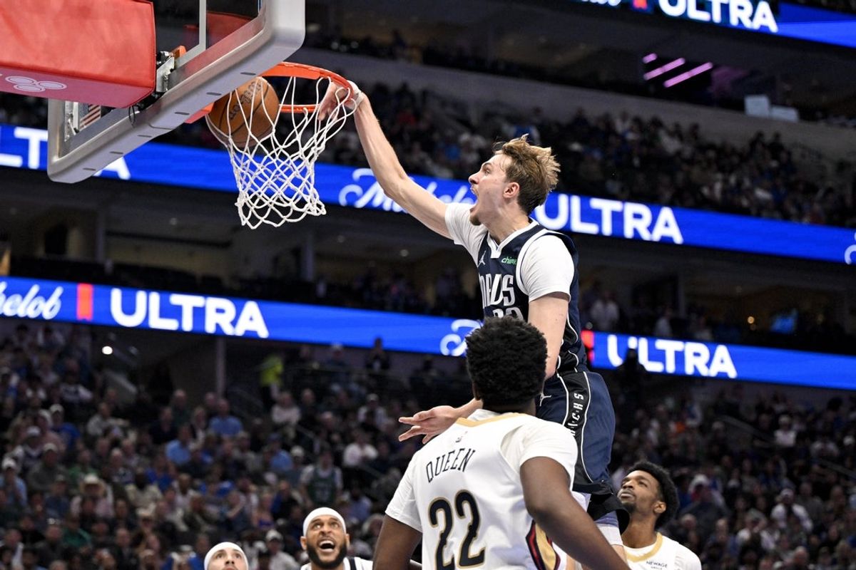 Nov 21, 2025; Dallas, Texas, USA; Dallas Mavericks forward Cooper Flagg (32) dunks the ball over New Orleans Pelicans center Derik Queen (22) and forward Herbert Jones (2) during the second half at the American Airlines Center. Mandatory Credit: Jerome Miron-Imagn Images