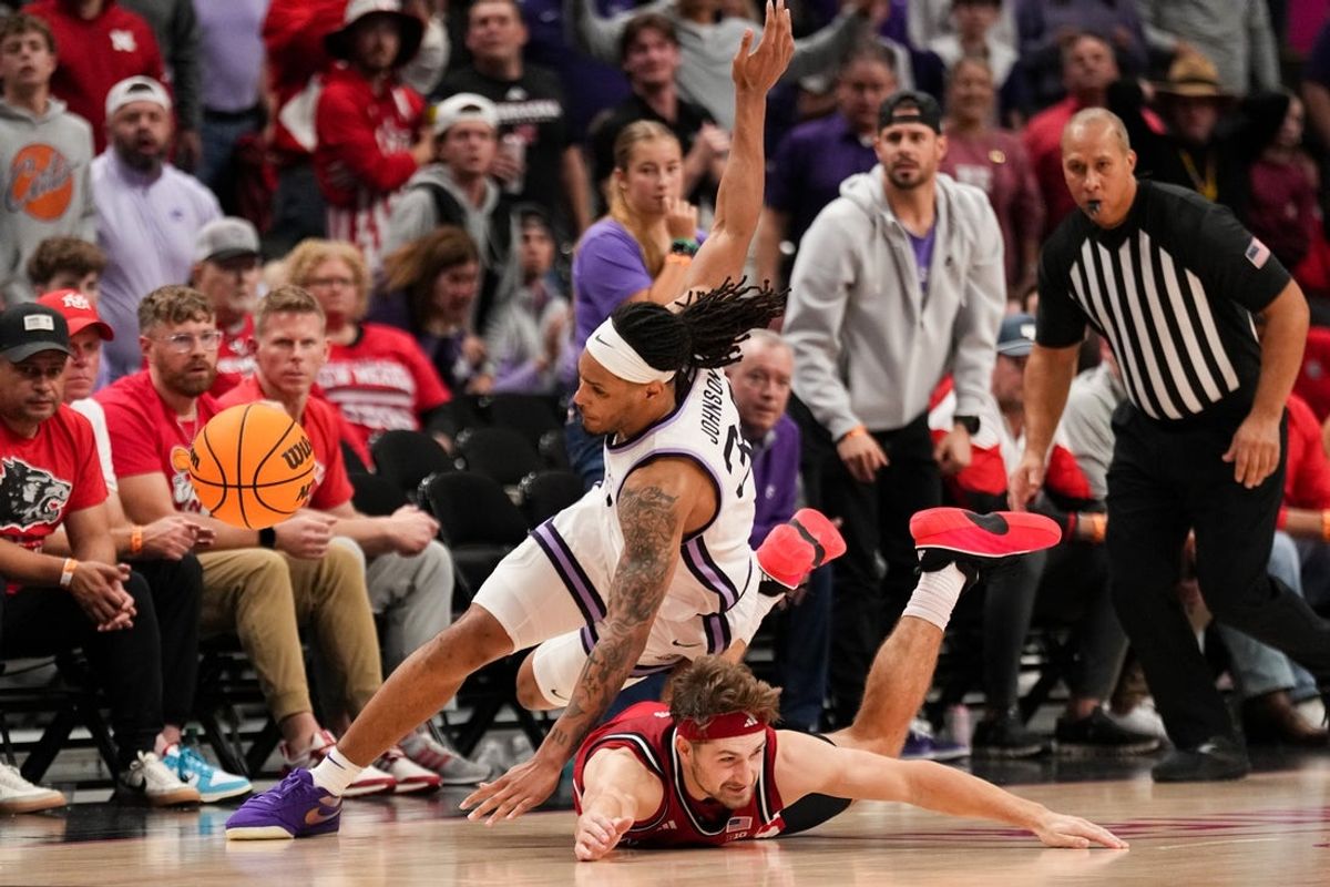 Nov 21, 2025; Kansas City, MO, USA; Nebraska Cornhuskers guard Sam Hoiberg (1) and Kansas State Wildcats guard Nate Johnson (34) collide scrambling for a loose ball during the second half of the game at T-Mobile Center. Mandatory Credit: Denny Medley-Imagn Images