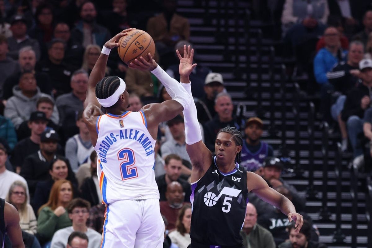 Nov 21, 2025; Salt Lake City, Utah, USA; Oklahoma City Thunder guard Shai Gilgeous-Alexander (2) shoots as Utah Jazz forward Cody Williams (5) defends during the second half at Delta Center. Mandatory Credit: Rob Gray-Imagn Images