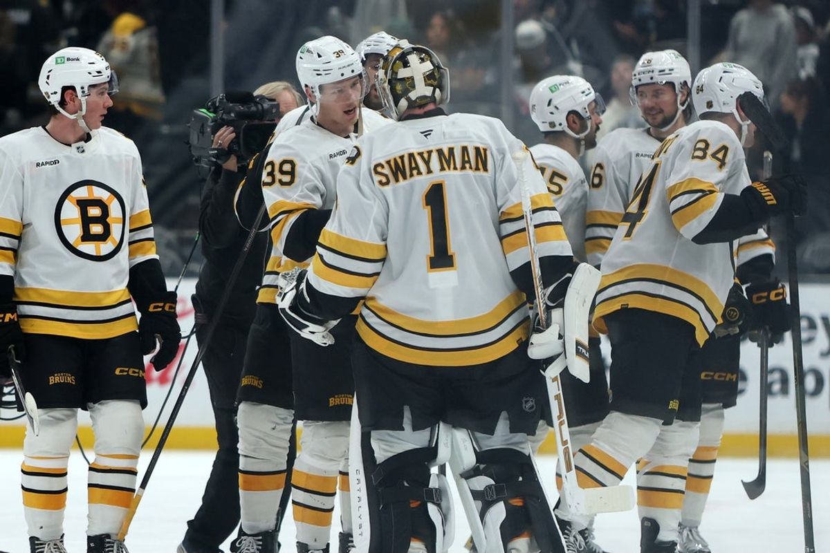 Nov 21, 2025; Los Angeles, California, USA;  Boston Bruins center Morgan Geekie (39) celebrates with goaltender Jeremy Swayman (1) after scoring a game winning goal in the overtime against the Los Angeles Kings at Crypto.com Arena. Mandatory Credit: Kiyoshi Mio-Imagn Images