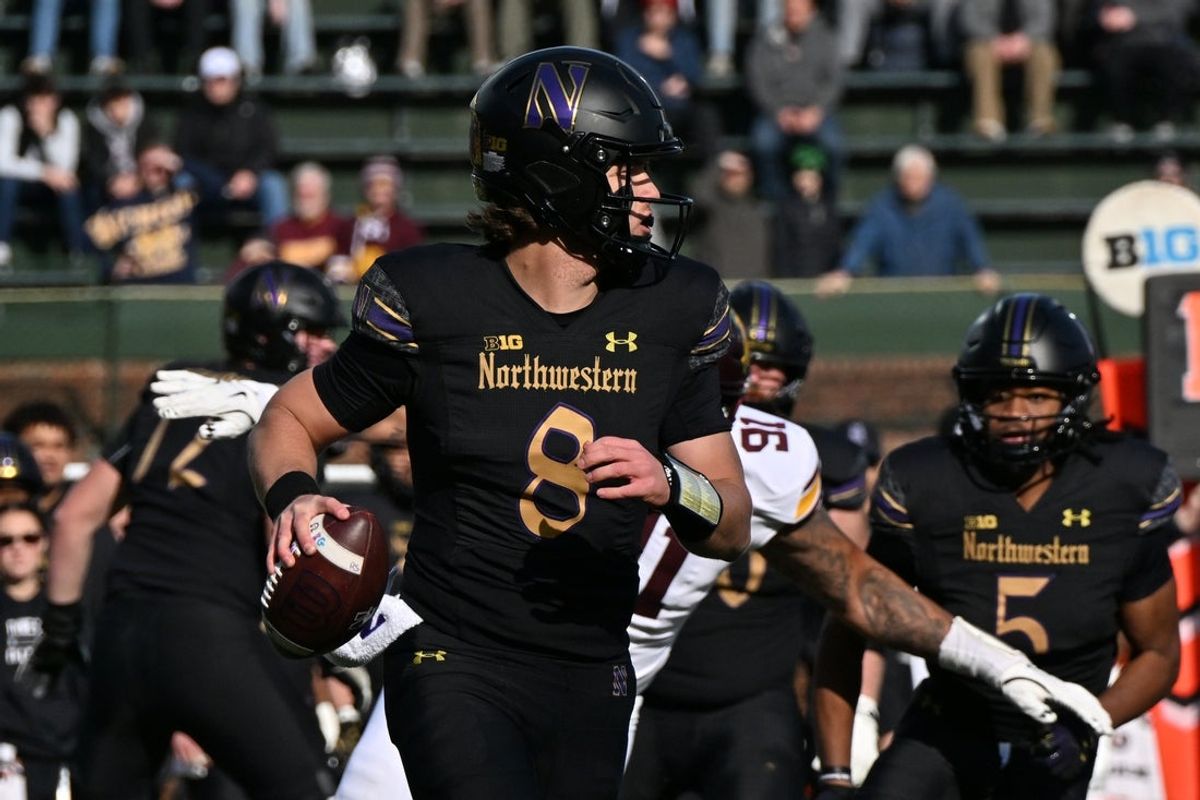Nov 22, 2025; Chicago, Illinois, USA; Northwestern Wildcats quarterback Preston Stone (8) scans the field against the Minnesota Golden Gophers during the first half at Wrigley Field. Mandatory Credit: Patrick Gorski-Imagn Images