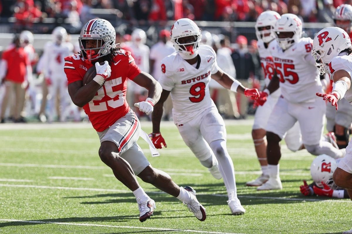 Nov 22, 2025; Columbus, Ohio, USA; Ohio State Buckeyes running back Bo Jackson (25) runs for a fifteen-yard touchdown against Rutgers Scarlet Knights defensive back Jett Elad (9) during the first quarter at Ohio Stadium. Mandatory Credit: Joseph Maiorana-Imagn Images