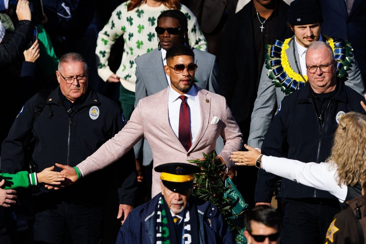 Notre Dame head coach Marcus Freeman, center, walks into Notre Dame Stadium with his players before a NCAA football game against Syracuse on Saturday, Nov. 22, 2025, in South Bend.