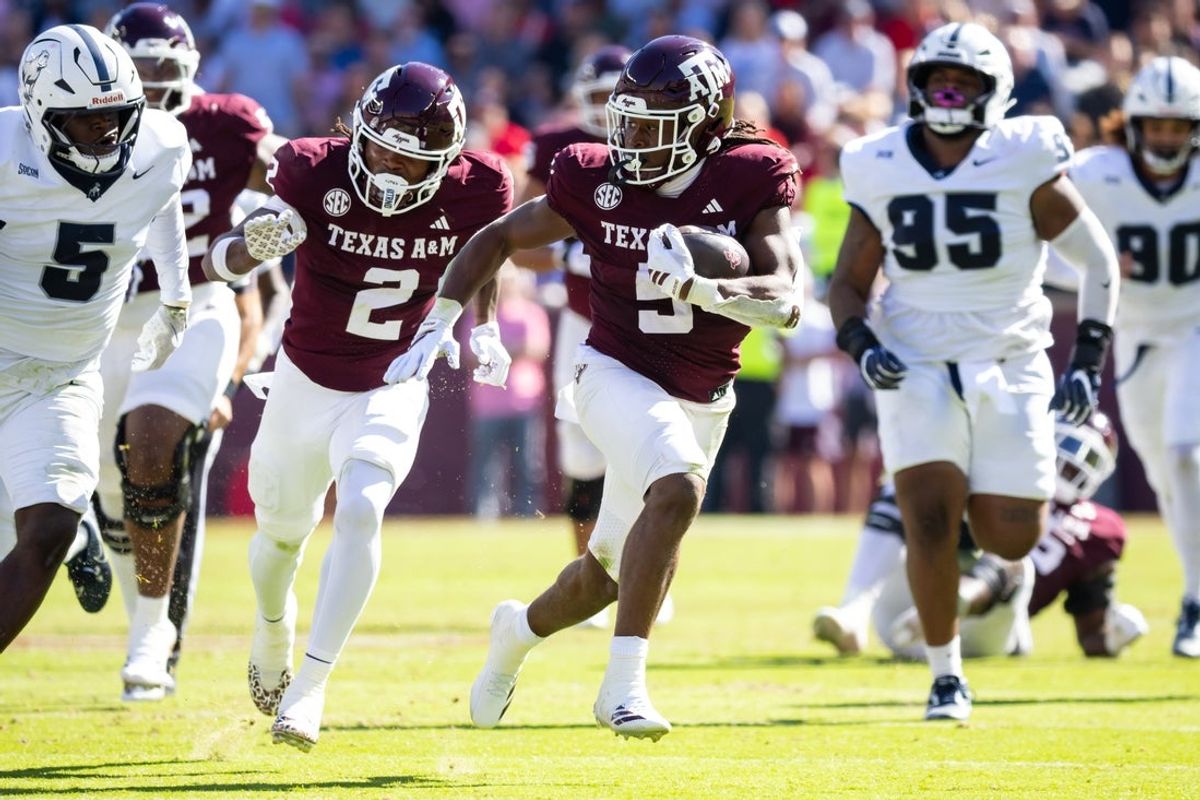 Nov 22, 2025; College Station, Texas, USA; Texas A&M Aggies running back Amari Daniels (5) runs with the ball in the first half of a game against the Samford Bulldogs at Kyle Field. Mandatory Credit: Joseph Buvid-Imagn Images