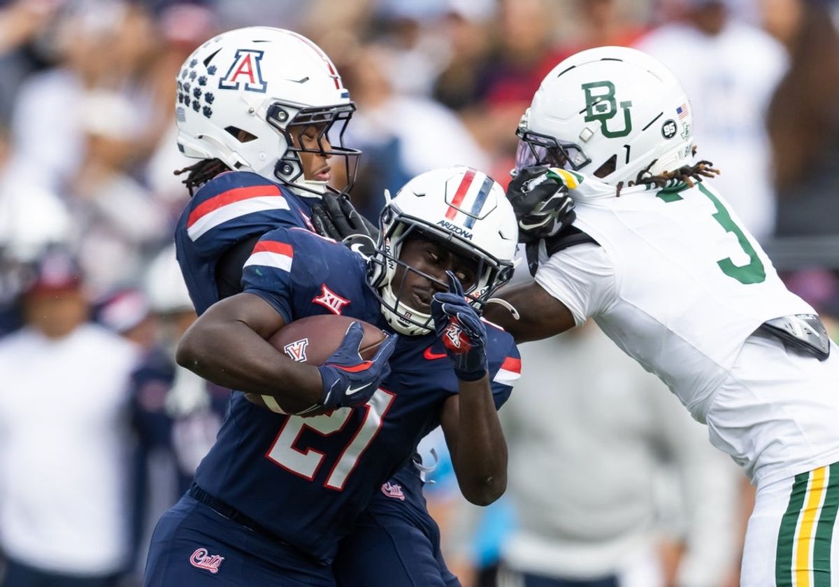 Nov 22, 2025; Tucson, Arizona, USA; Arizona Wildcats running back Ismail Mahdi (21) against the Baylor Bears in the first half at Casino Del Sol Stadium. Mandatory Credit: Mark J. Rebilas-Imagn Images