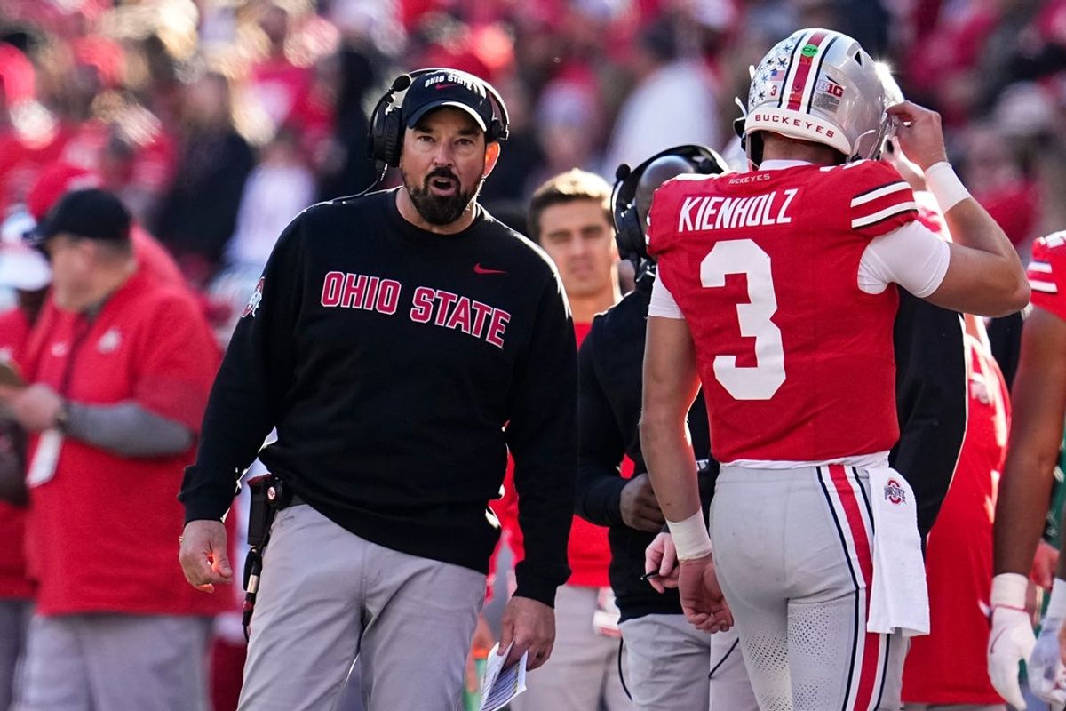 Ohio State Buckeyes head coach Ryan Day talks to quarterback Lincoln Kienholz (3) during the second half of the NCAA football game against the Rutgers Scarlet Knights at Ohio Stadium in Columbus on Nov. 22, 2025. Ohio State won 42-9.