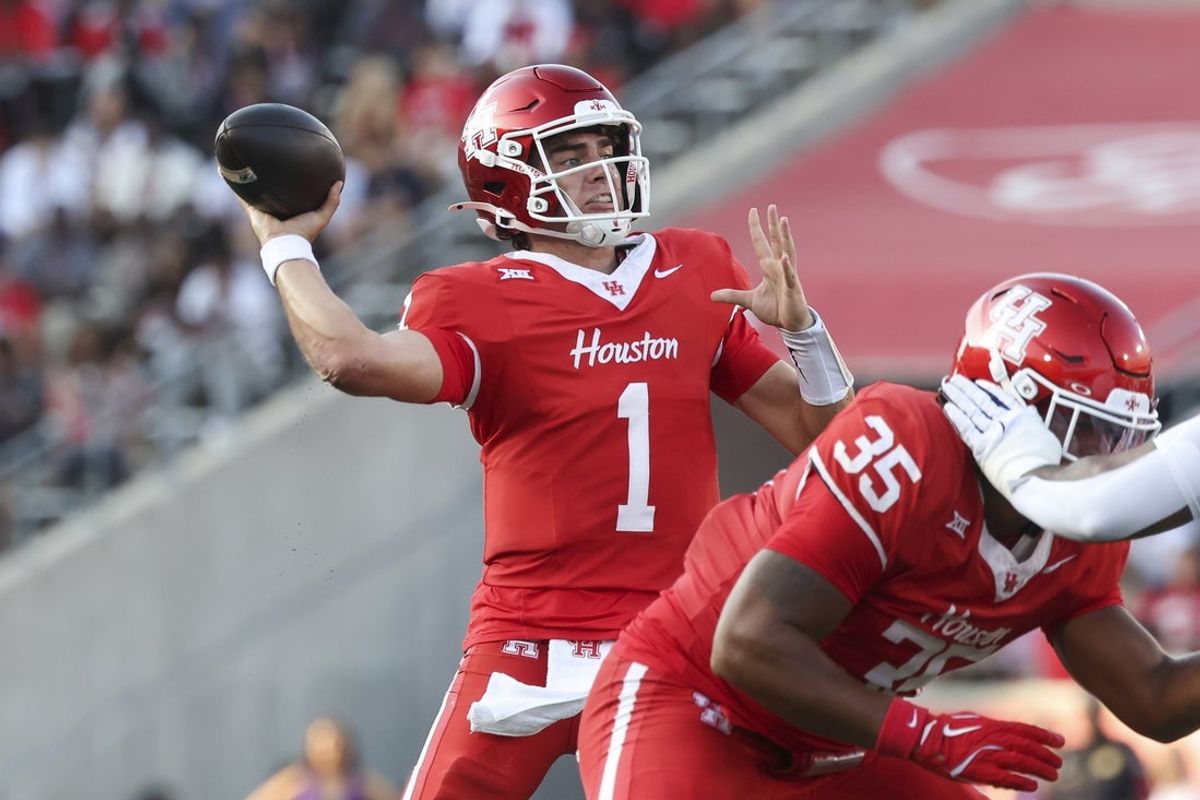 Nov 22, 2025; Houston, Texas, USA; Houston Cougars quarterback Conner Weigman (1) throws a pass for a touchdown during the second quarter against the TCU Horned Frogs at TDECU Stadium. Mandatory Credit: Troy Taormina-Imagn Images